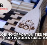 Wooden cutting board displayed beside pile of small oars, top one with letters EOP carved into it