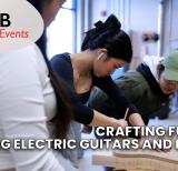 Three students work with piece of wood in shape of guitar