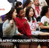 Students sitting on the floor drumming