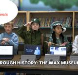 Four students stand behind tablets displaying information. Each is dressed as a different historical Canadian. 