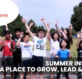 group of young campers stand outside cheering