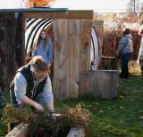 students work in garden with hoop house in the background
