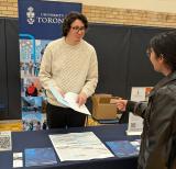 student speaking with university recruiter