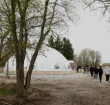 Students walk towards white geodesic dome